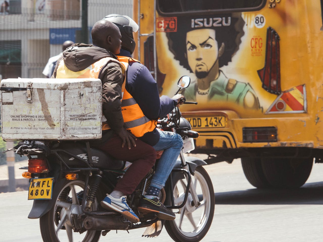 services-04 Motorcycle delivery service in Nairobi with vibrant street art in the background.